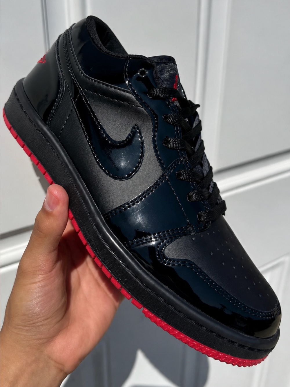 Jordan 1 Menโs Black Patent Leather Low-Top Sneakers with Red sole N/A